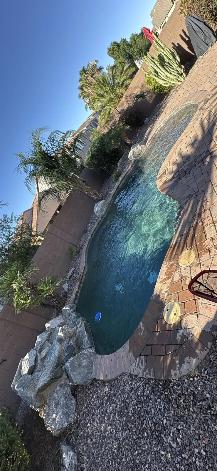 Rock waterfall feature with efflorescence staining on a San Tan Valley Arizona pool