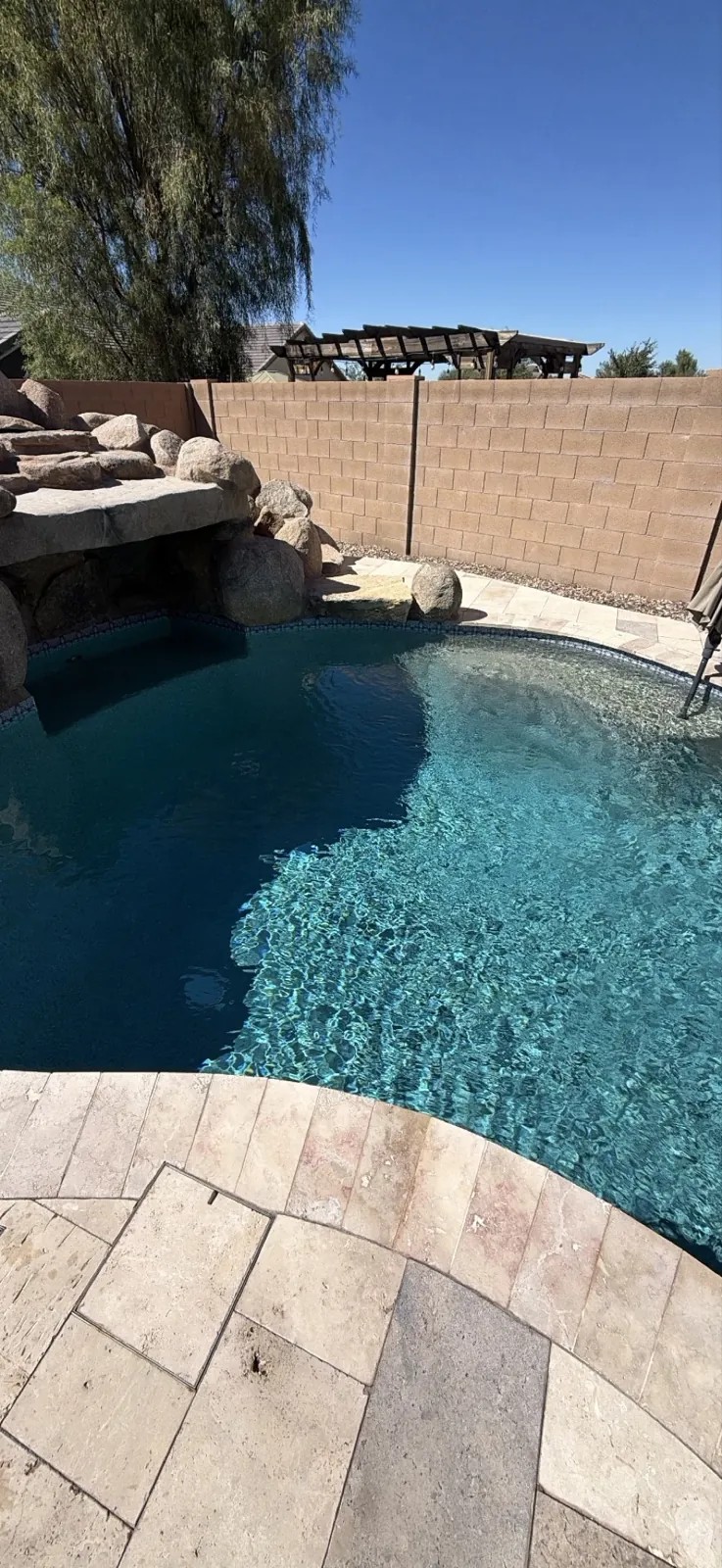 Boulder waterfall and stacked-stone ledge with no buildup, San Tan Valley Arizona pool