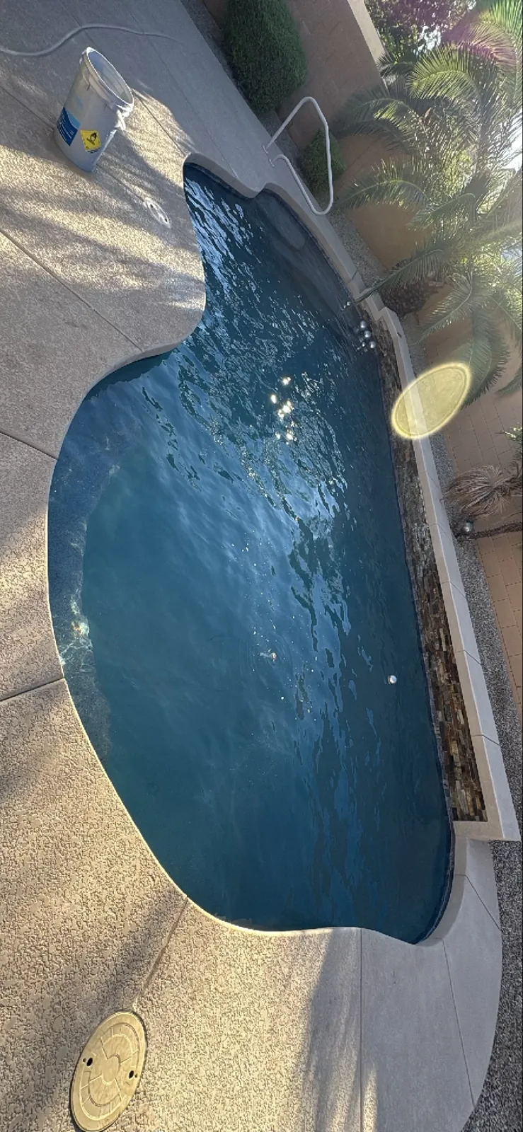 Aerial view of stacked-stone accent wall with deck jets, San Tan Valley Arizona pool
